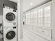 Hallway features stackable washer/dryer next to built-in white storage at 423 N Snowmass Cir, Superior, CO 80027