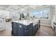 Bright open kitchen with white cabinets, hardwood floors, and an island with bar seating at 423 N Snowmass Cir, Superior, CO 80027