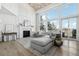 Bright living room with vaulted ceilings, a fireplace, and large windows overlooking the outdoor view at 423 N Snowmass Cir, Superior, CO 80027