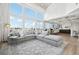 Open-concept living area with a large sectional sofa, a fireplace, and backyard views at 423 N Snowmass Cir, Superior, CO 80027