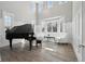 Bright living room featuring a grand piano, high ceilings, hardwood floors and large windows with an elegant seating area at 423 N Snowmass Cir, Superior, CO 80027