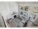 Bright living room with high ceilings, a fireplace, and large windows providing panoramic views and ample natural light at 423 N Snowmass Cir, Superior, CO 80027