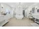 Luxurious main bathroom featuring a freestanding tub, elegant chandelier, and custom cabinetry, designed for ultimate relaxation at 423 N Snowmass Cir, Superior, CO 80027