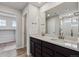 Bright bathroom featuring a double vanity with sleek fixtures and quartz countertops and a glass-enclosed shower at 14441 Clover Dr, Mead, CO 80504