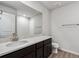 Modern bathroom with large mirror, quartz countertops, wood-look tile floor and a walk-in shower at 14441 Clover Dr, Mead, CO 80504