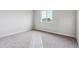 Bright bedroom with large window, soft carpet, and neutral walls provides peaceful space at 14441 Clover Dr, Mead, CO 80504