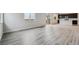 Bright living room with luxury vinyl floors, neutral walls, and large windows at 14441 Clover Dr, Mead, CO 80504