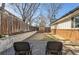 Large backyard with potential for landscaping, featuring a greenhouse and stone pathways at 1740 Shavano St, Longmont, CO 80504