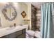 Bathroom features a shower with patterned shower curtain, and a gray vanity with a white countertop at 1740 Shavano St, Longmont, CO 80504