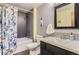 Bathroom with modern fixtures including patterned shower curtain, and a neutral toned vanity at 1740 Shavano St, Longmont, CO 80504