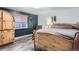 Cozy bedroom with dark walls, wood accents, natural light and wood-look floors at 1740 Shavano St, Longmont, CO 80504