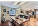 Dining room with a rustic table and modern light fixture, connecting to the kitchen at 1740 Shavano St, Longmont, CO 80504