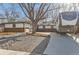 Ranch style house with mature trees, rock landscaping, and a large driveway with an RV at 1740 Shavano St, Longmont, CO 80504