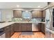 Well-lit kitchen featuring stainless steel appliances, mosaic backsplash, and stylish cabinets at 1740 Shavano St, Longmont, CO 80504
