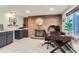 Office space featuring a brick fireplace and built-in cabinets for storage and a cozy workspace at 1740 Shavano St, Longmont, CO 80504