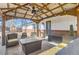 Cozy outdoor seating area with comfortable furniture, overhead shelter, and attractive string lights at 1740 Shavano St, Longmont, CO 80504