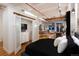 Open loft bedroom with modern features and a peek into the kitchen at 2955 Inca St # 2F, Denver, CO 80202