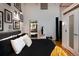 Modern bedroom with a monochromatic theme, hardwood floors, ensuite bathroom, and unique decorative features at 2955 Inca St # 2F, Denver, CO 80202
