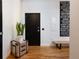 Entryway with hardwood floors, a modern bench, and striking artwork highlighting city districts at 2955 Inca St # 2F, Denver, CO 80202