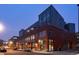 Brick apartment building with large windows and modern design at dusk at 2955 Inca St # 2F, Denver, CO 80202
