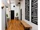 Hallway with high ceilings, wooden floors, wall decor, and a modern bench at 2955 Inca St # 2F, Denver, CO 80202