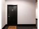 Hallway featuring a black door marked '2F' and a 'Welcome' mat, creating a simple entrance at 2955 Inca St # 2F, Denver, CO 80202
