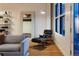 A brightly lit living room with hardwood floors, Eames chair, and a view of the city at 2955 Inca St # 2F, Denver, CO 80202