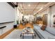 Open concept living space with projector screen, kitchen, and dining area with hardwood flooring at 2955 Inca St # 2F, Denver, CO 80202