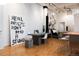 Open living space with modern artwork, dining area, and bedroom alcove, featuring an industrial design at 2955 Inca St # 2F, Denver, CO 80202