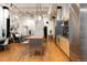 Open living space featuring a modern kitchen island, stainless steel appliances and adjacent seating at 2955 Inca St # 2F, Denver, CO 80202