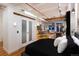 Bedroom with kitchen view features hardwood flooring, comfortable furnishings, and soft lighting at 2955 Inca St # 2F, Denver, CO 80202