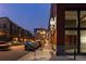 Street view showcasing modern architecture and evening ambiance, with parked cars and streetlights at 2955 Inca St # 2F, Denver, CO 80202