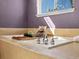 Stylish primary bathroom features a soaking tub and window with natural light at 3853 S Malta St, Aurora, CO 80013