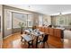 Bright dining area with large windows, wood floors, and seating for six at 3853 S Malta St, Aurora, CO 80013