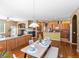 Open dining area with hardwood floors, pendant lighting, and seating for six at 3853 S Malta St, Aurora, CO 80013