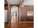 Inviting entryway with hardwood floors and arched openings into the living spaces offers an elegant welcome at 3853 S Malta St, Aurora, CO 80013