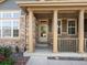 Inviting front porch with stately columns, creating a warm and welcoming entrance to this charming home at 3853 S Malta St, Aurora, CO 80013
