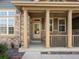 Inviting front porch with stately columns, creating a warm and welcoming entrance to this charming home at 3853 S Malta St, Aurora, CO 80013