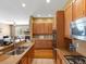 Gourmet kitchen with stainless steel appliances, wooden cabinets, granite countertops, and hardwood floors at 3853 S Malta St, Aurora, CO 80013