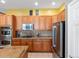 Kitchen with stainless steel appliances, tile floors, and wooden cabinets at 3853 S Malta St, Aurora, CO 80013