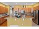 Kitchen with breakfast bar, tile backsplash, and stainless steel appliances at 3853 S Malta St, Aurora, CO 80013