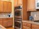 Kitchen featuring stainless steel oven and microwave and granite countertops at 3853 S Malta St, Aurora, CO 80013