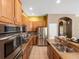 Well-equipped kitchen with stainless steel appliances, granite countertops, tile flooring, and wooden cabinetry at 3853 S Malta St, Aurora, CO 80013