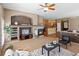 Open living room with fireplace, ceiling fan, and view into the kitchen at 3853 S Malta St, Aurora, CO 80013