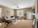 Bright living room with neutral tones, ceiling fan, and access to the outdoors at 3853 S Malta St, Aurora, CO 80013
