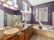 Elegant main bathroom with a soaking tub, double sinks, and a glass-enclosed shower offers a private retreat at 3853 S Malta St, Aurora, CO 80013