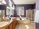 Luxurious main bathroom with double sinks, a soaking tub, and a glass-enclosed shower provides a spa-like experience at 3853 S Malta St, Aurora, CO 80013