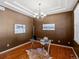 Well-lit office with hardwood floors, modern chandelier, and desk provides a functional workspace at 3853 S Malta St, Aurora, CO 80013