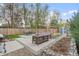 Relaxing backyard with paved patio, stylish outdoor furniture, garden beds, string lights, and privacy fence at 1645 Wabash St, Denver, CO 80220
