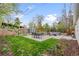 Large backyard with grassy lawn, patio, outdoor dining set, cozy seating, shed, and lush landscaping at 1645 Wabash St, Denver, CO 80220